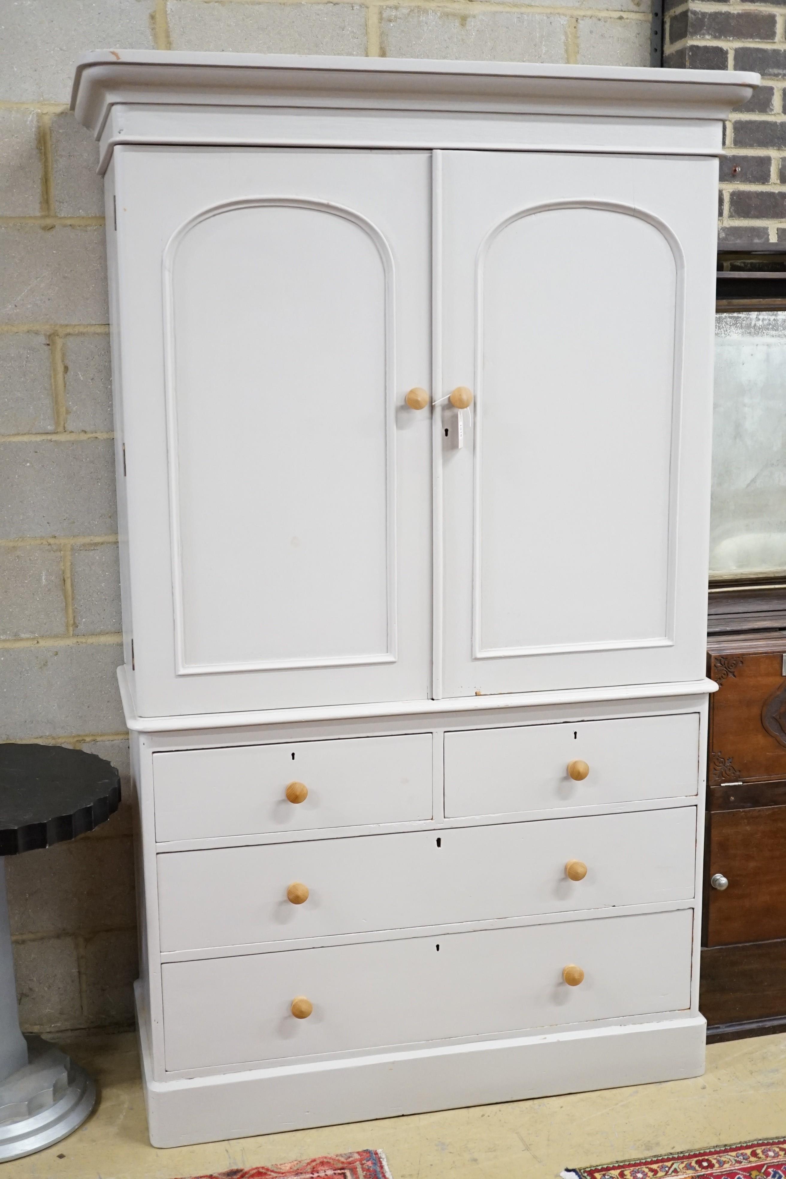 A Victorian later painted pine linen press, with two doors enclosing sliding trays, width 130cm, height 208cm